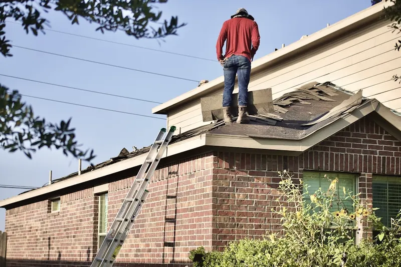 Professional roofer working on a residential roof in Fort Salonga